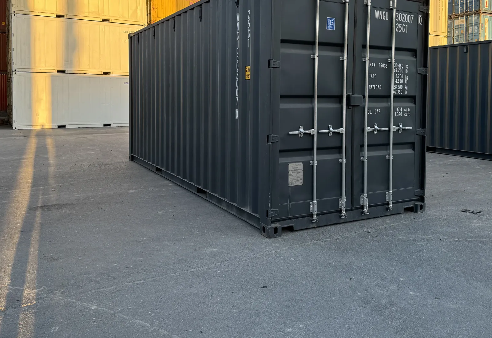 New single-trip 20ft high cube shipping container in dark grey at the container yard